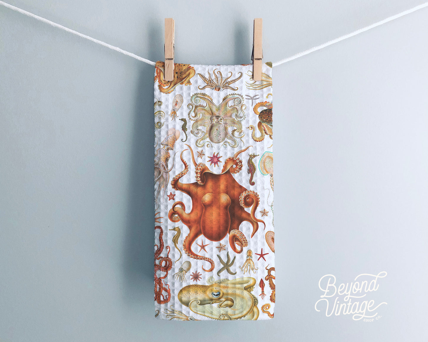 a towel hanging on a clothes line with octopuses