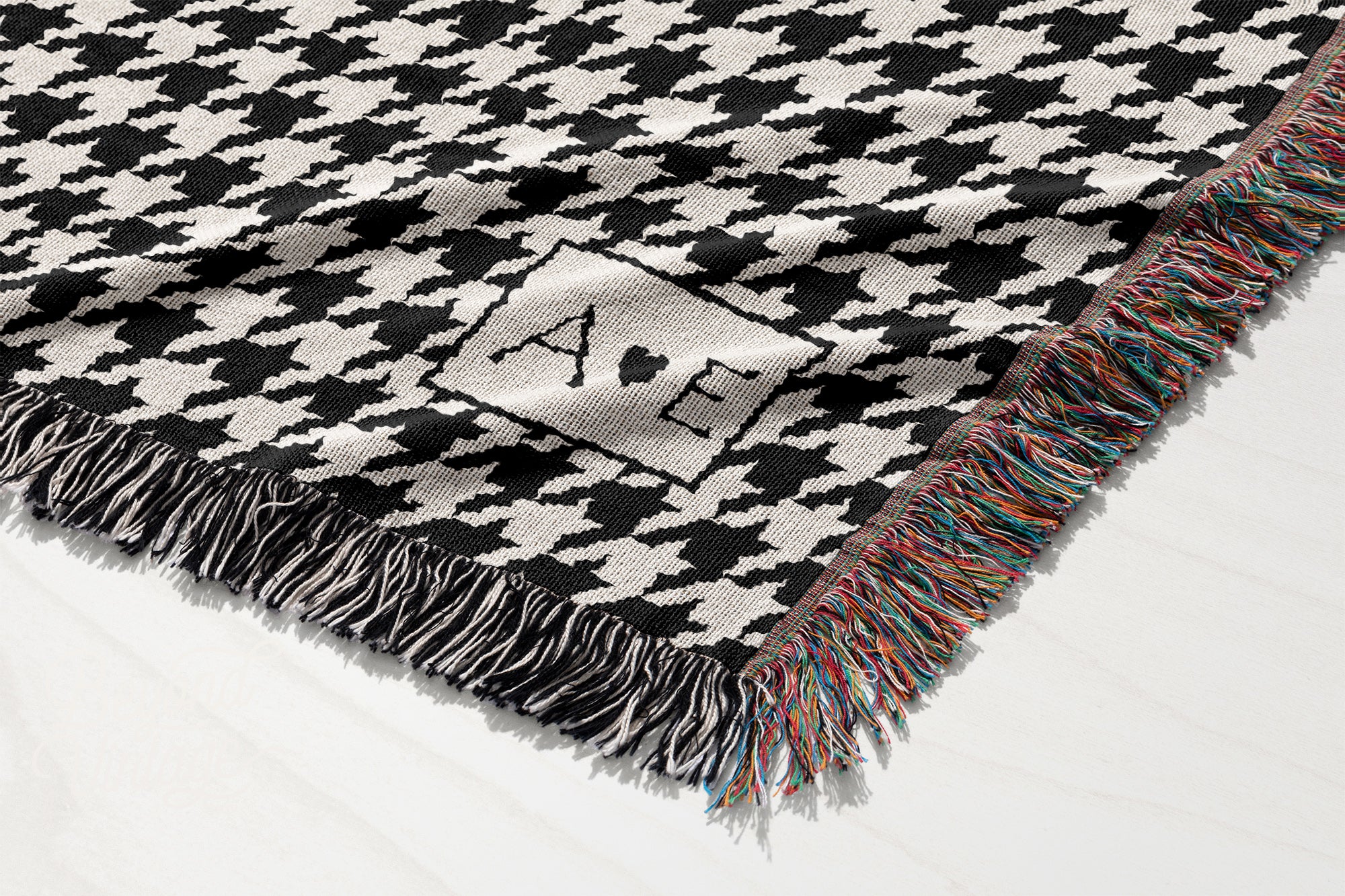 a black and white blanket with a logo on it