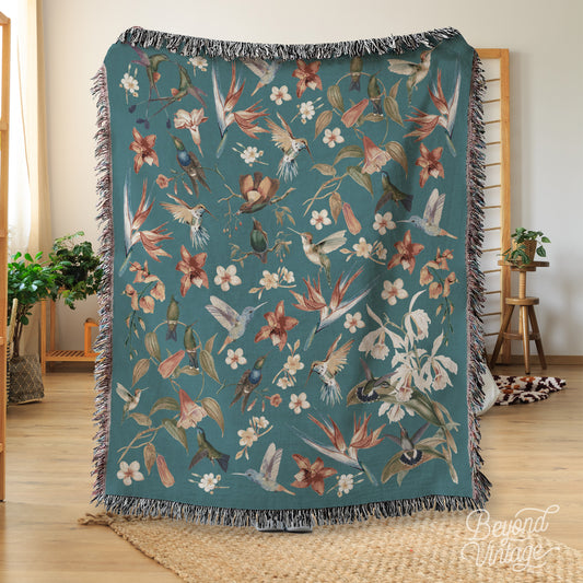 a blanket with birds and flowers on it