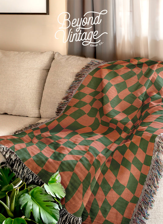 a living room with a couch covered in a blanket