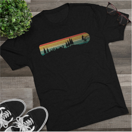 a black t - shirt with a sunset and trees on it