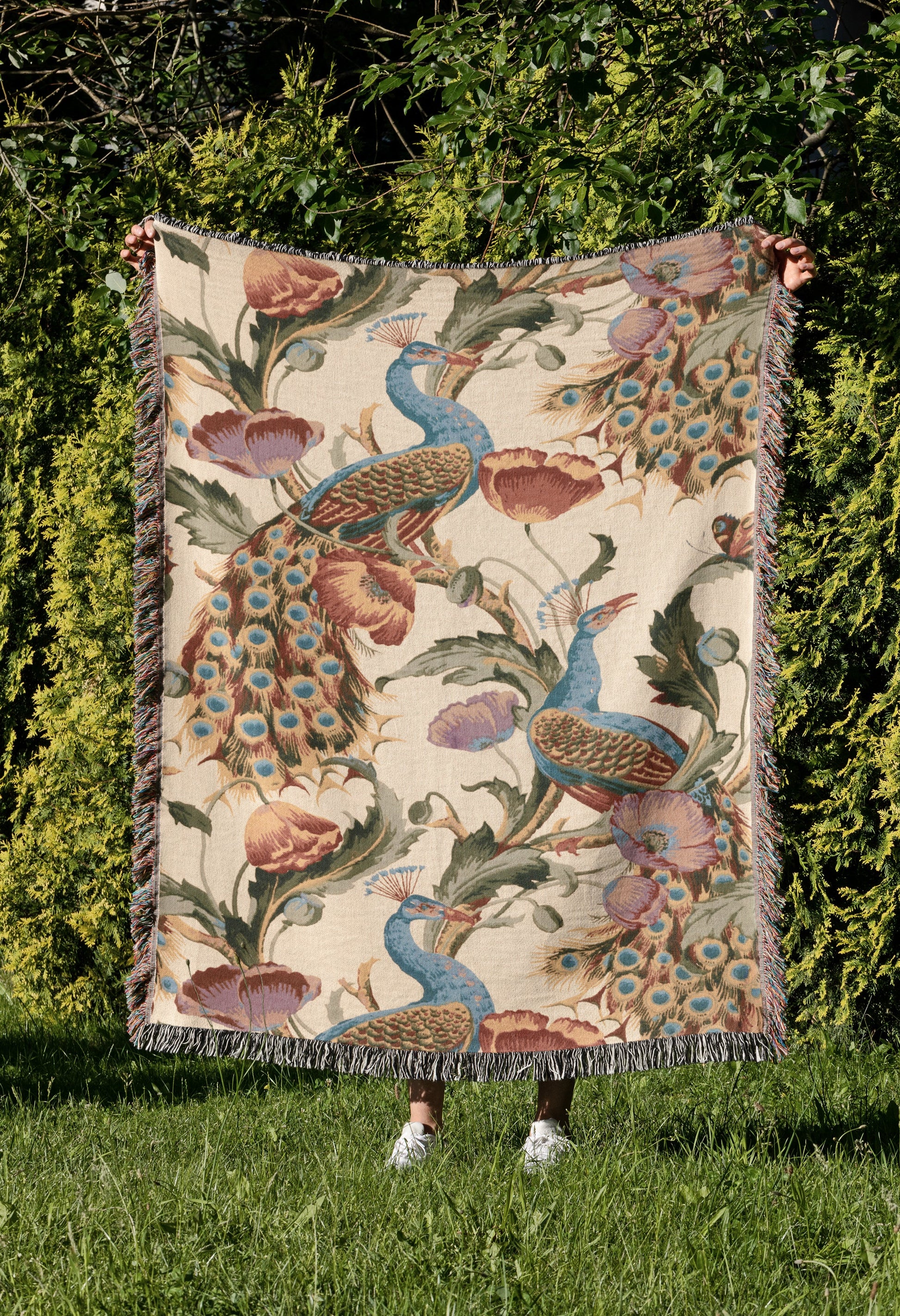 a blanket with a peacock design on it