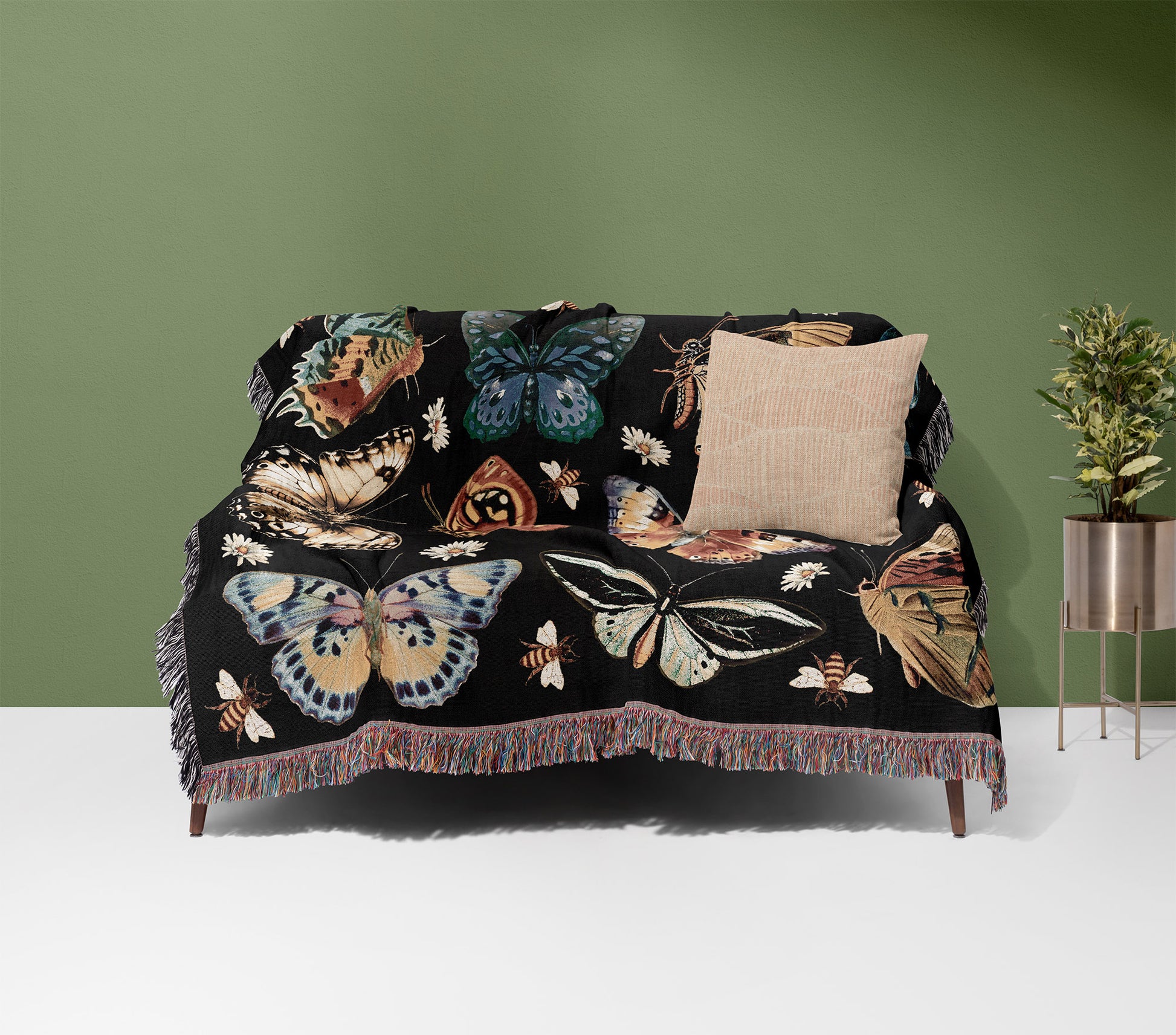 a couch covered in a blanket with butterflies on it