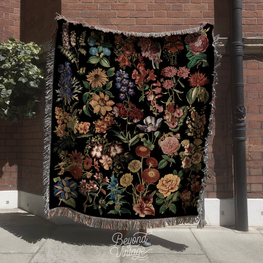 a black blanket with a bunch of flowers on it