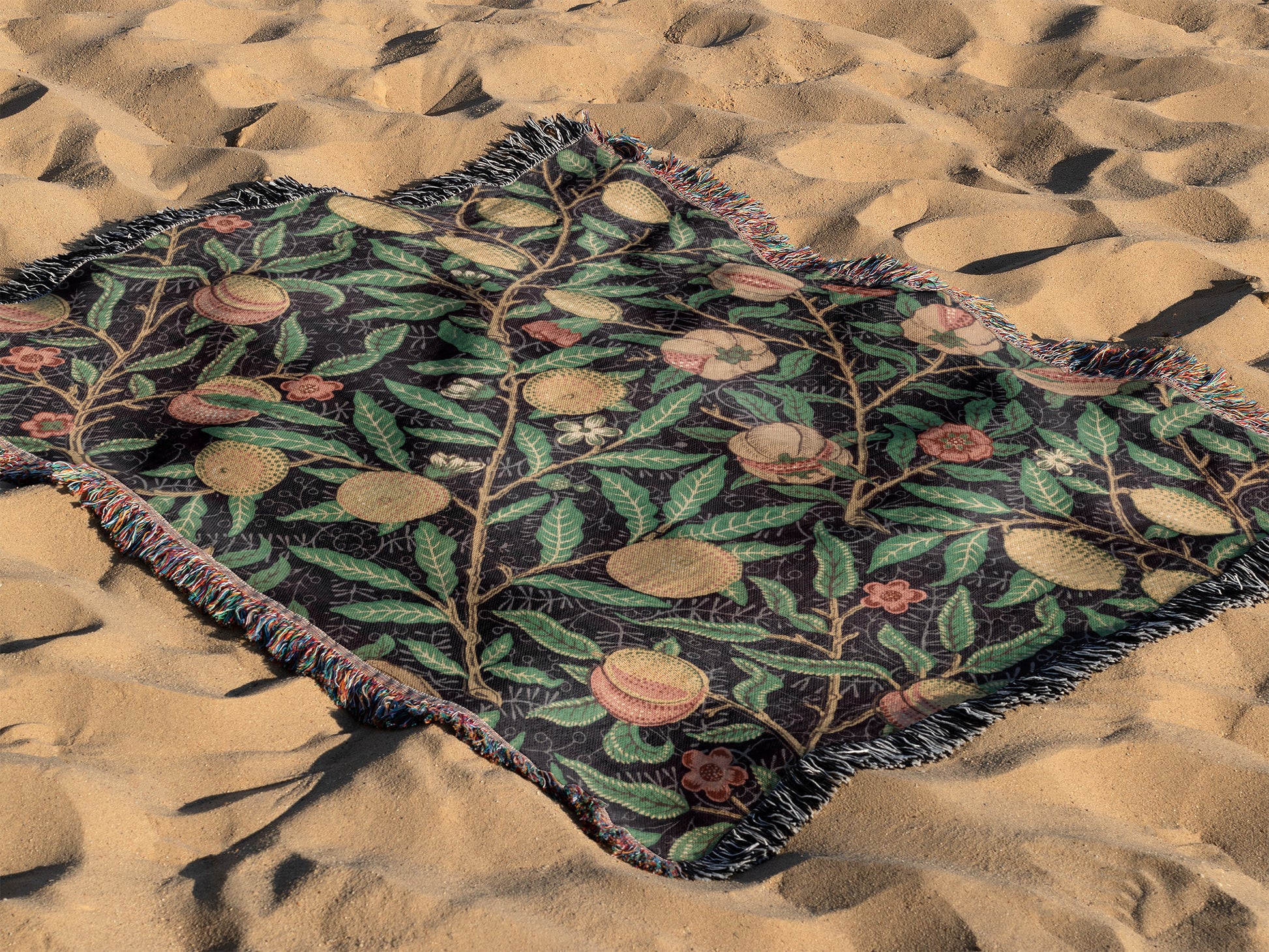 a blanket laying on top of a sandy beach