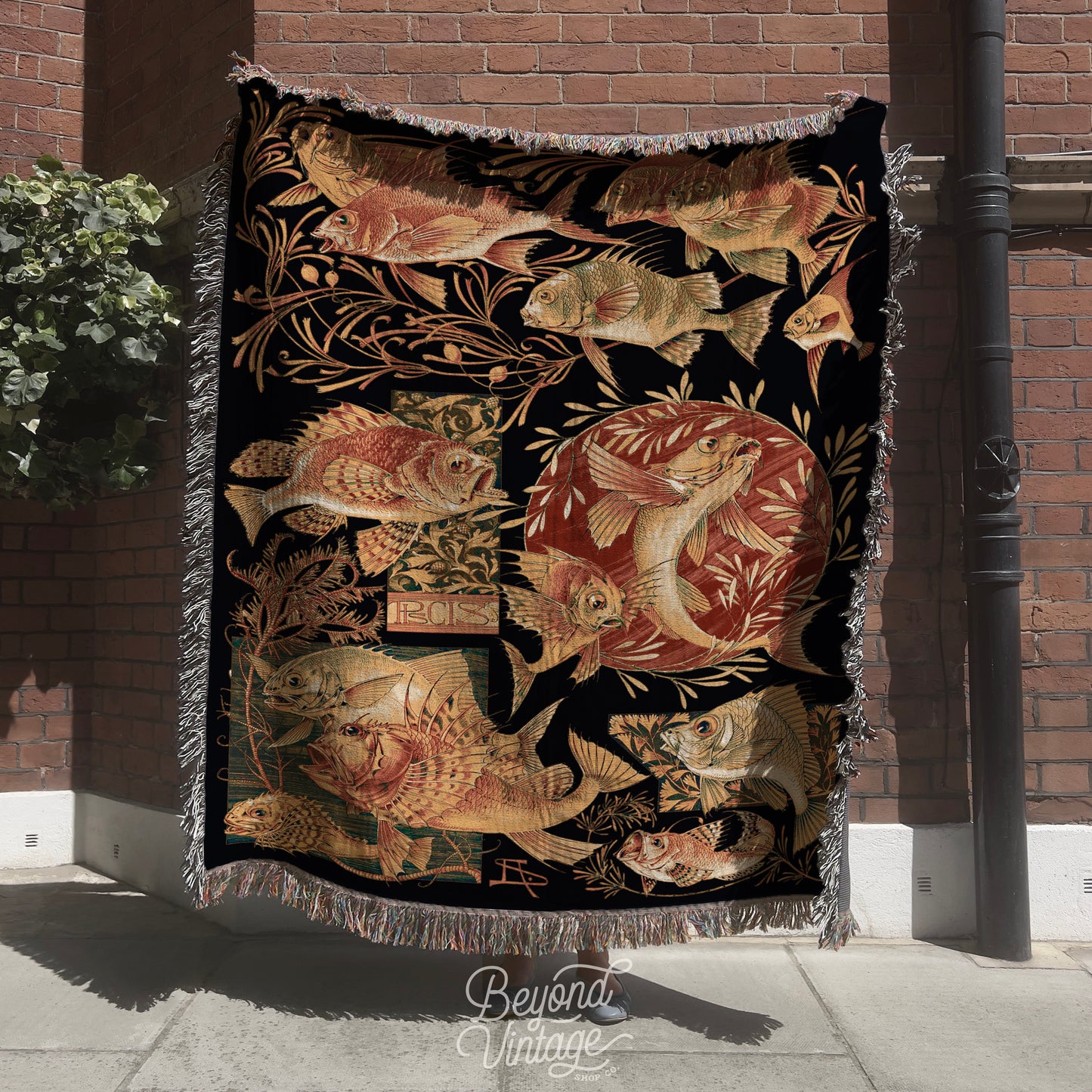 a tapestry hanging on a pole on a sidewalk