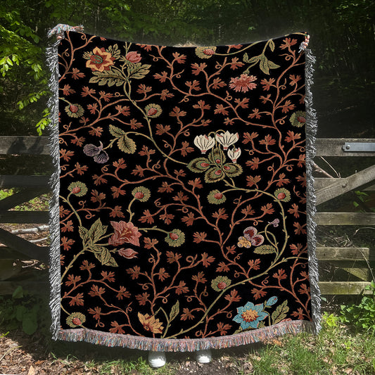 a black blanket with a floral design on it