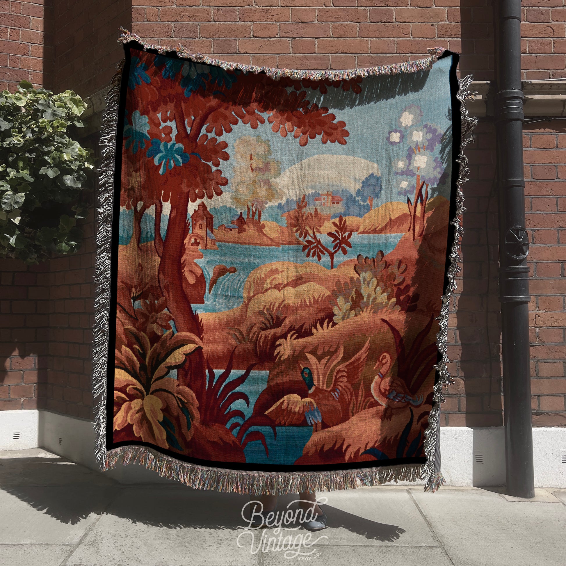 a large tapestry hanging on the side of a building