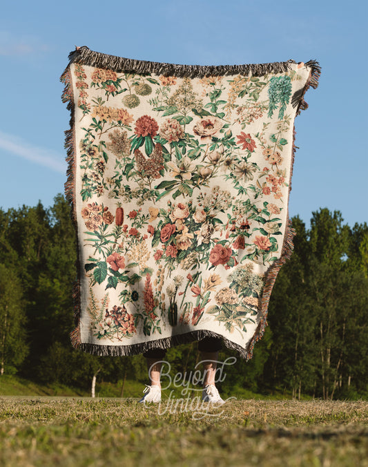 a blanket hanging from a pole in a field