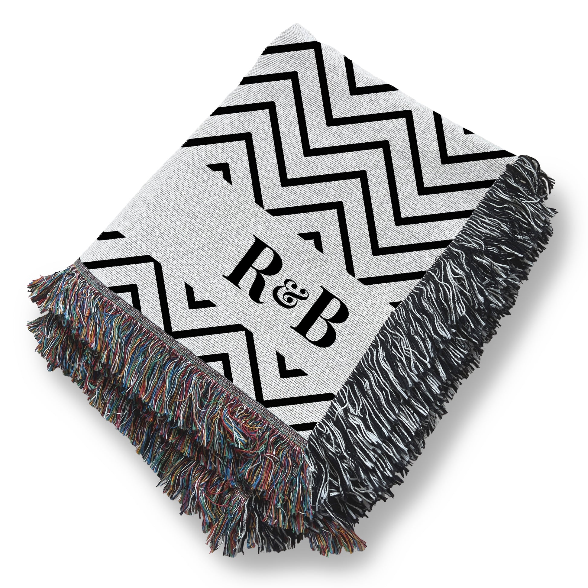 a black and white blanket with a monogrammed r & b on it