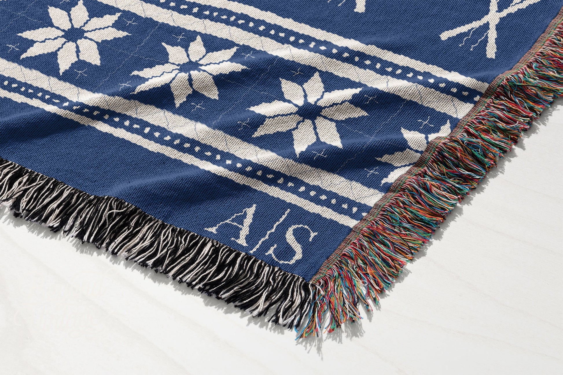 a blue and white blanket with snowflakes on it