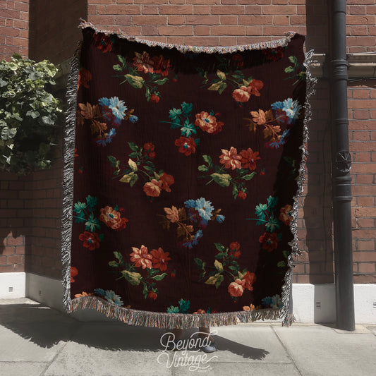 a blanket hanging on a pole on a sidewalk