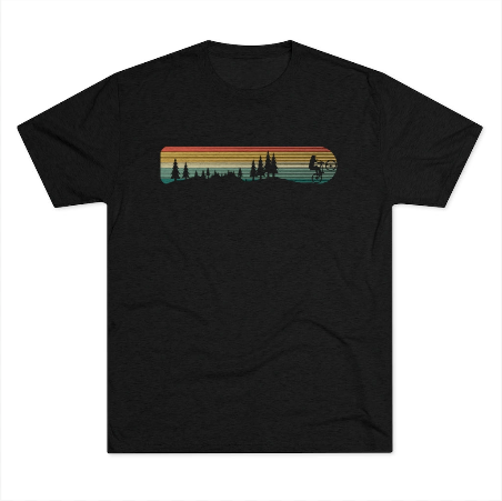 a black t - shirt with a sunset and trees on it