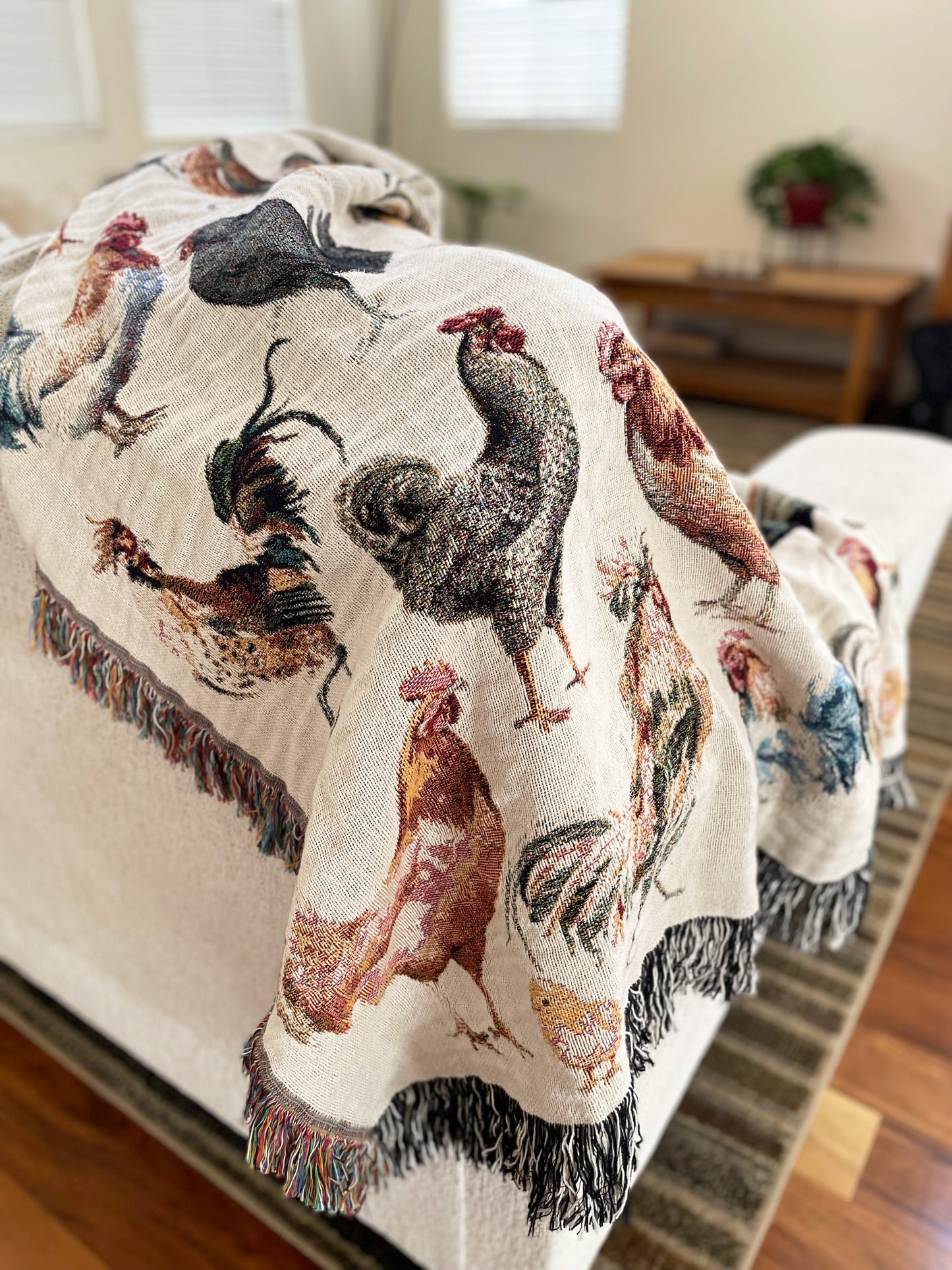 a bed covered in a blanket with roosters on it