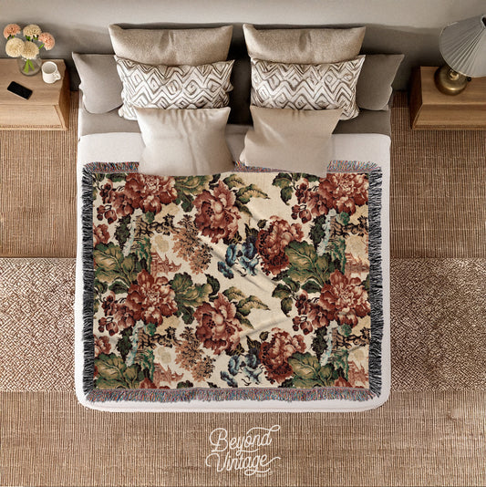 a bed with a floral comforter and pillows