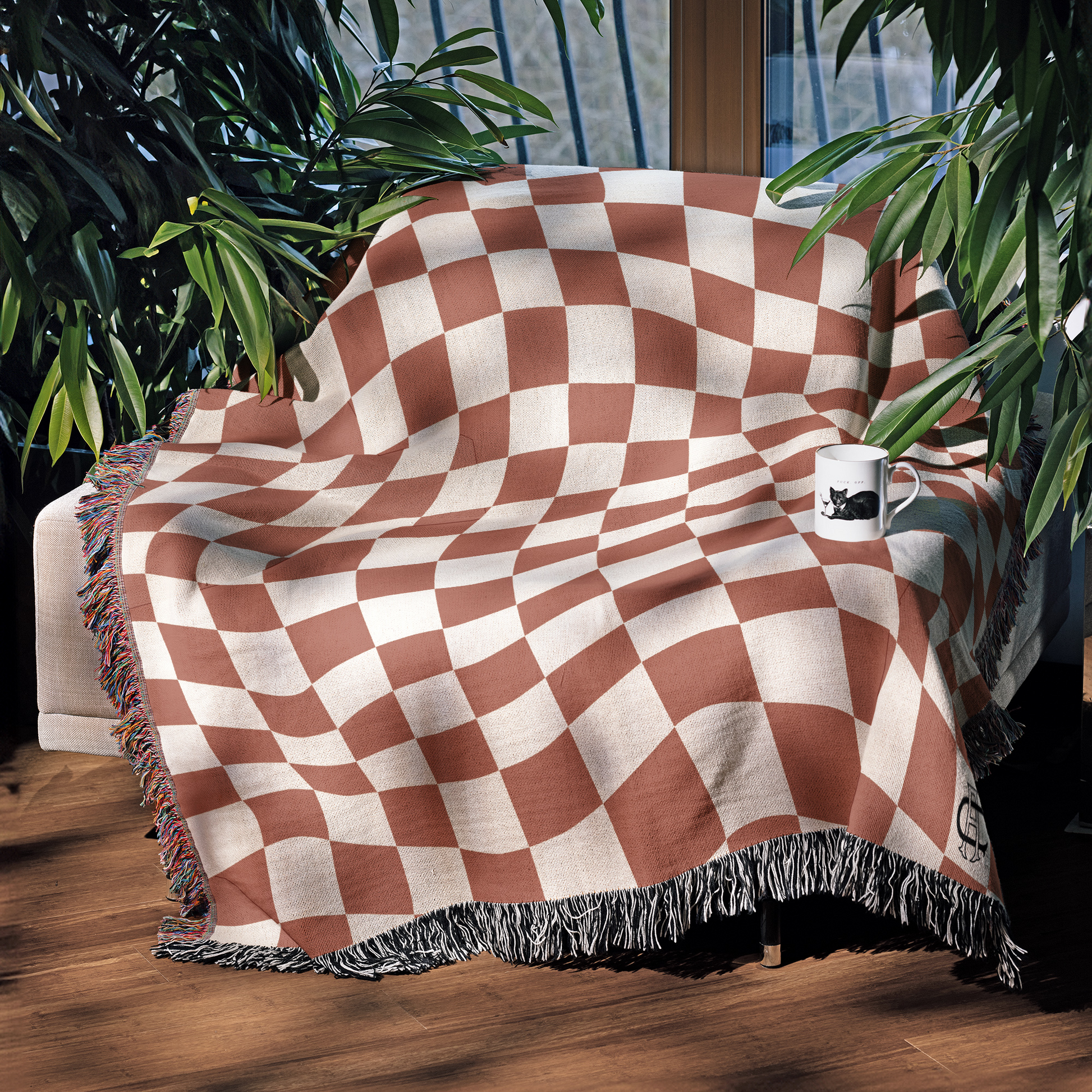 a checkered blanket sitting on top of a wooden floor