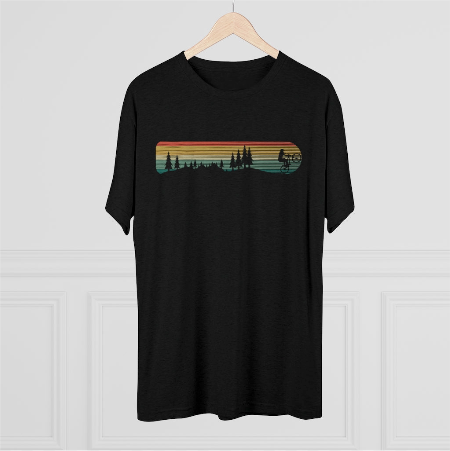 a black t - shirt with a sunset in the background