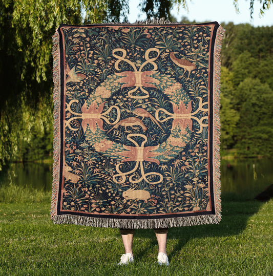a woman standing in a field holding a tapestry