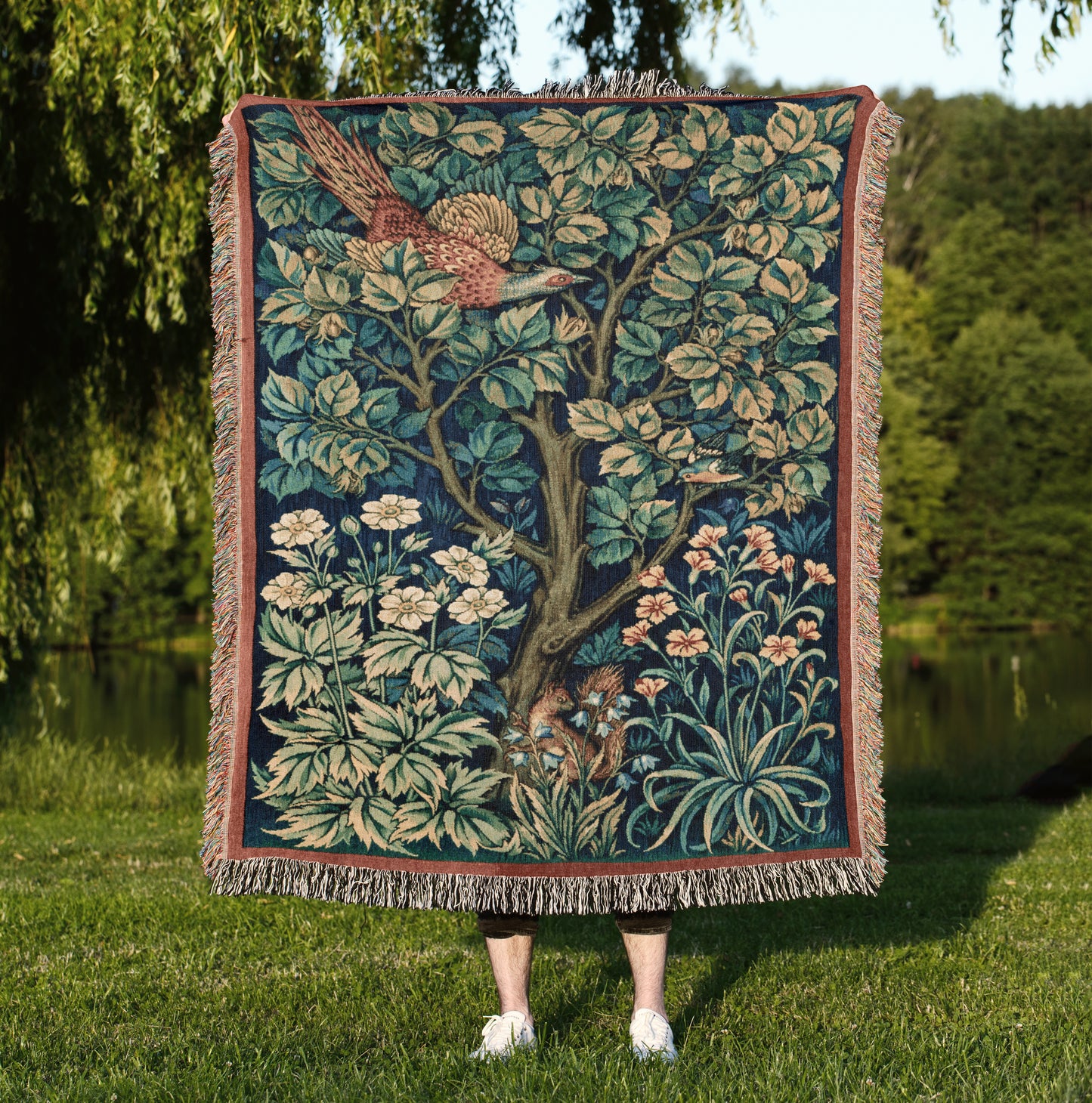 a woman standing in front of a tree of life tapestry