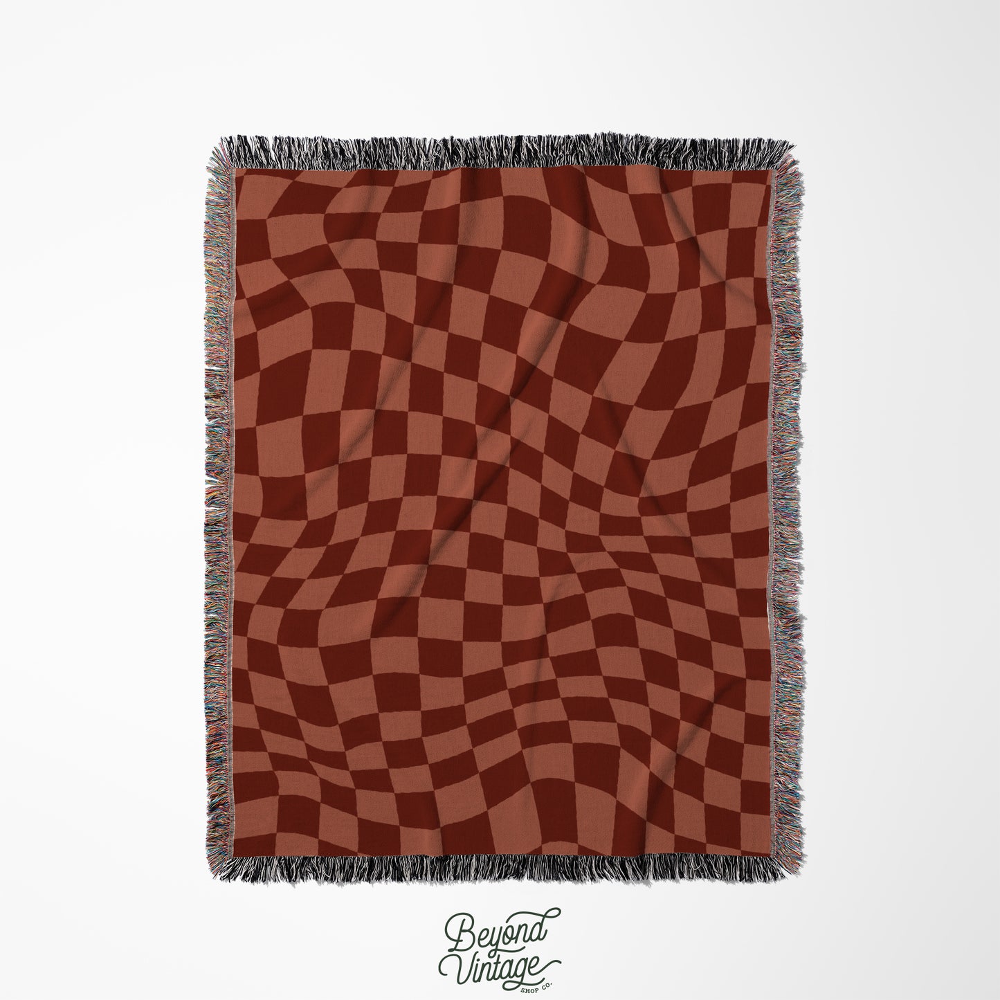 a red and brown checkered blanket with fringes