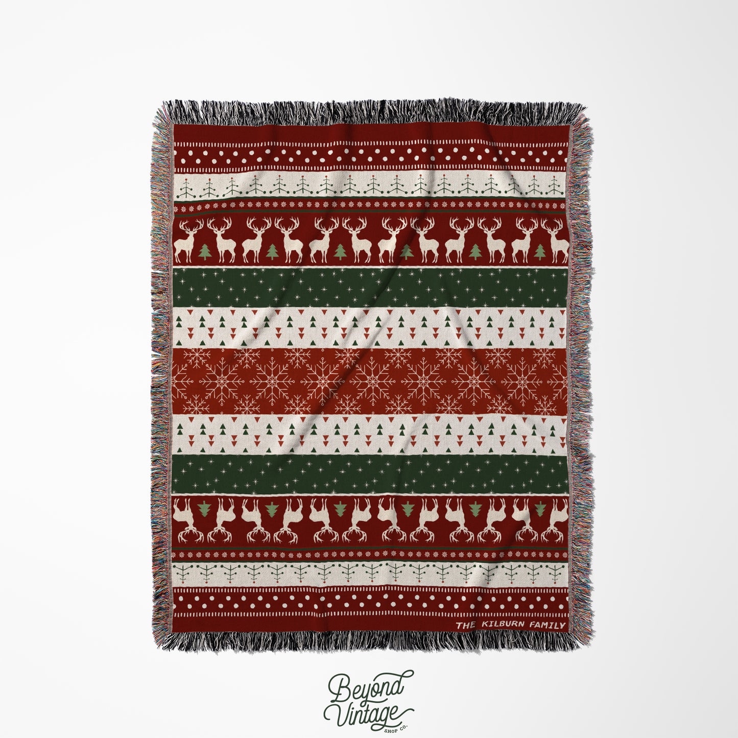 a red and green blanket with reindeers and snowflakes