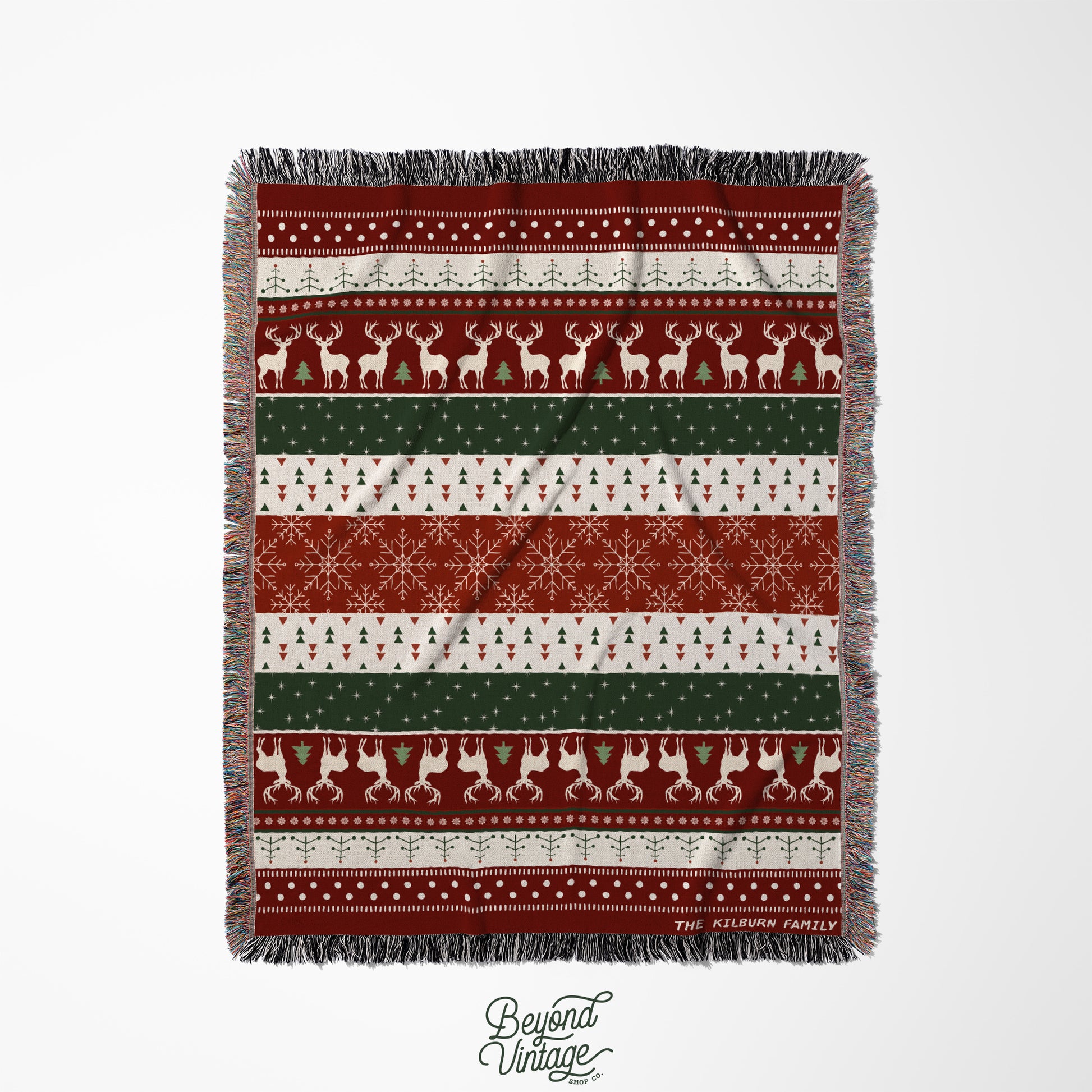 a red and green blanket with reindeers and snowflakes