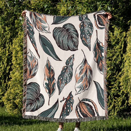 a blanket that has a pattern of leaves on it