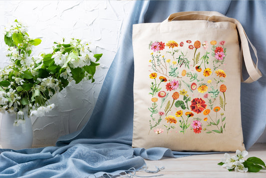a tote bag sitting on top of a table next to a vase of flowers