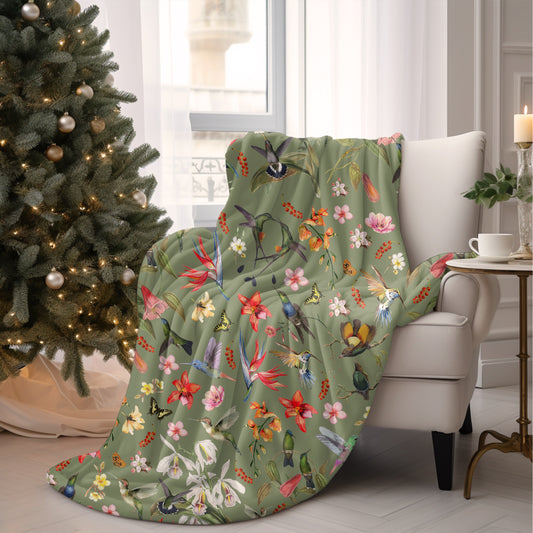 a living room with a christmas tree and a blanket