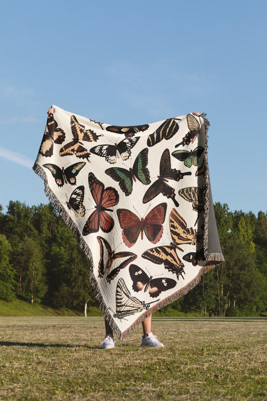 a woman is holding a blanket with butterflies on it