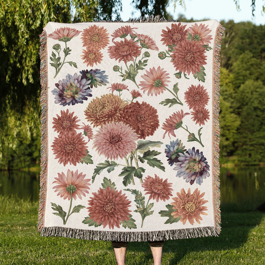 a woman holding a quilt with flowers on it