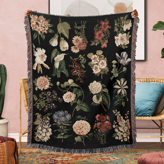 a black blanket with a bunch of flowers on it